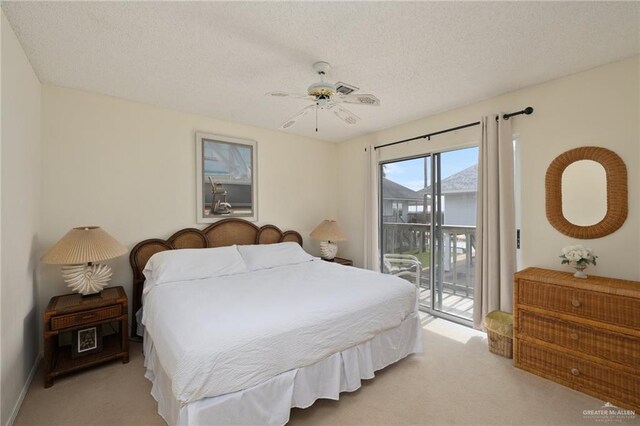 bedroom featuring a ceiling fan, access to outside, light carpet, and a textured ceiling