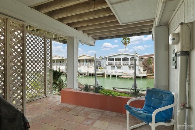 view of patio / terrace with a water view and a residential view