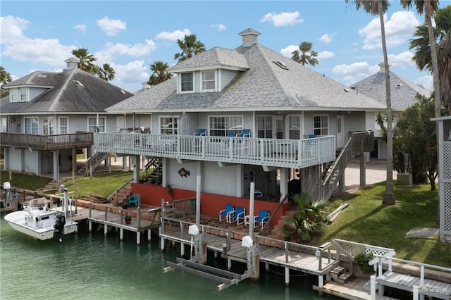 back of property featuring stairs, a yard, and boat lift