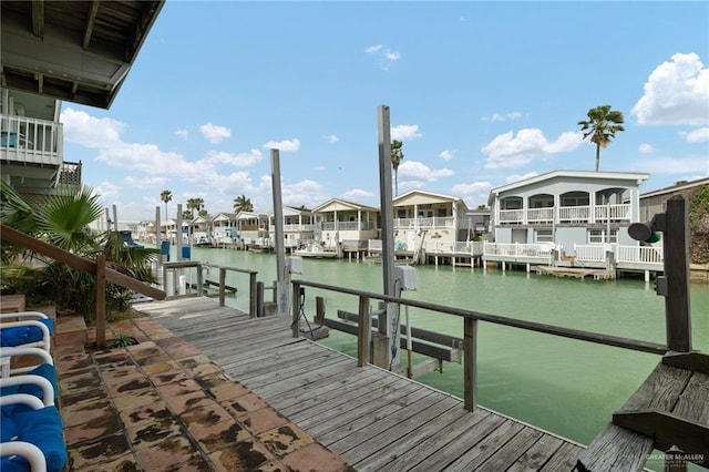 dock area with a water view and boat lift