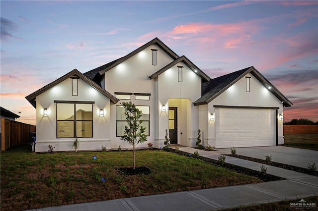 contemporary home with a yard and a garage