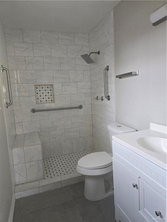 bathroom with vanity, a shower stall, and toilet