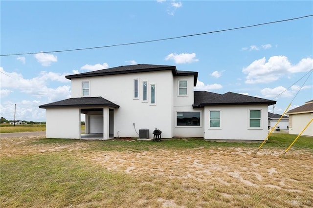 3306 Lauren Dr, Palmview, TX 78574 - rear view of property with central air condition unit, stucco siding, and a lawn