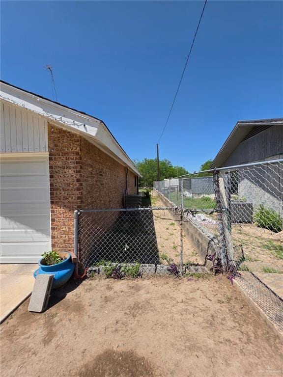 view of property exterior featuring fence, a garage, and concrete driveway