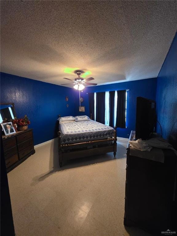 bedroom with a textured ceiling, baseboards, and a ceiling fan