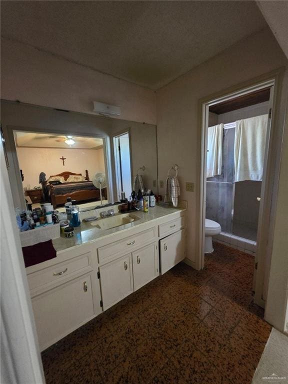full bath with toilet, a stall shower, and vanity