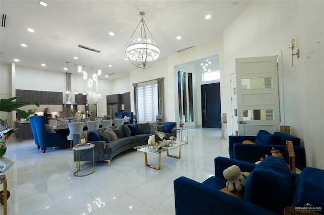 living room with light tile patterned floors, recessed lighting, a notable chandelier, a high ceiling, and visible vents