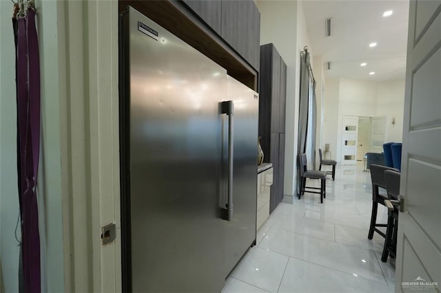 hallway with recessed lighting, visible vents, and light tile patterned floors