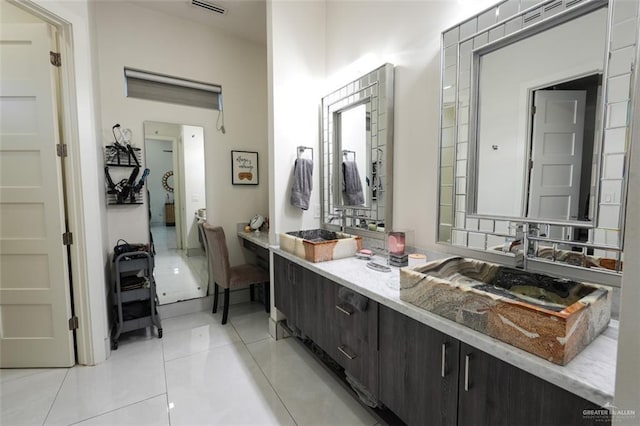 bathroom with double vanity, tile patterned flooring, and visible vents