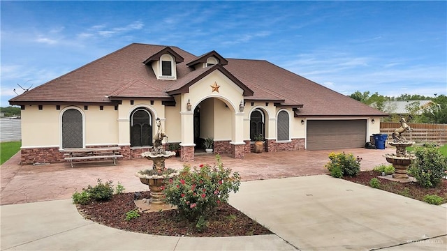 22613 N Sunflower Rd, Monte Alto, TX 78538 - view of front of house with stucco siding, concrete driveway, an attached garage, and a shingled roof