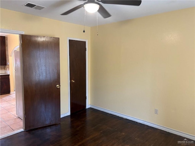 unfurnished bedroom with hardwood / wood-style flooring and ceiling fan