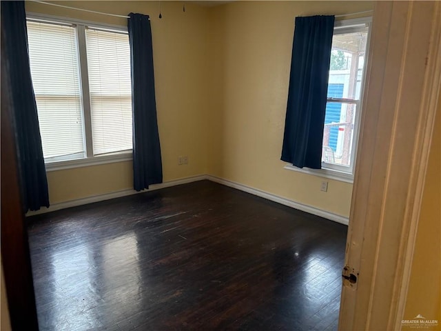 spare room with dark hardwood / wood-style floors