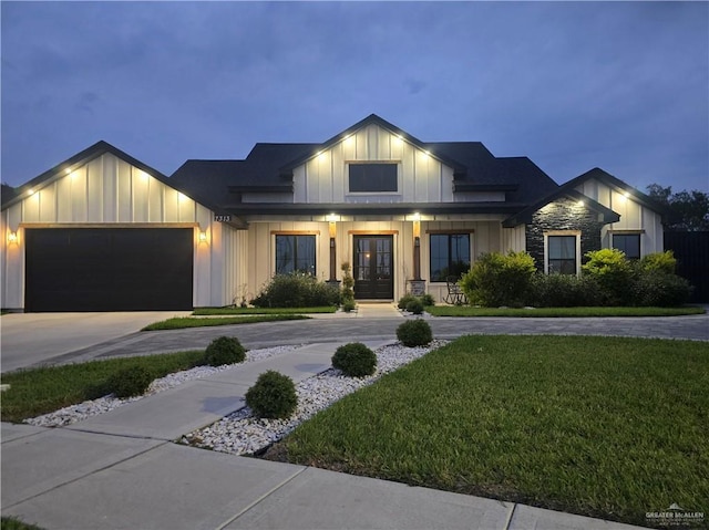 7313 N 25th Ln, Mcallen, TX 78504 - modern inspired farmhouse with a garage, board and batten siding, a front yard, concrete driveway, and french doors