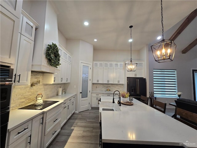 7313 N 25th Ln, Mcallen, TX 78504 - kitchen featuring decorative backsplash, light countertops, a chandelier, a sink, and black appliances