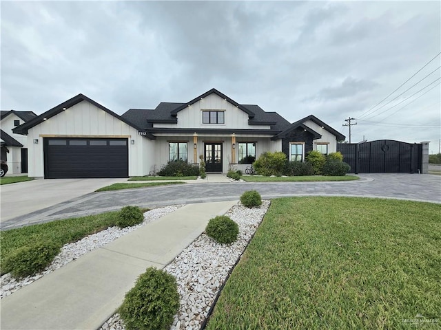7313 N 25th Ln, Mcallen, TX 78504 - modern farmhouse style home with french doors, board and batten siding, concrete driveway, and a front lawn