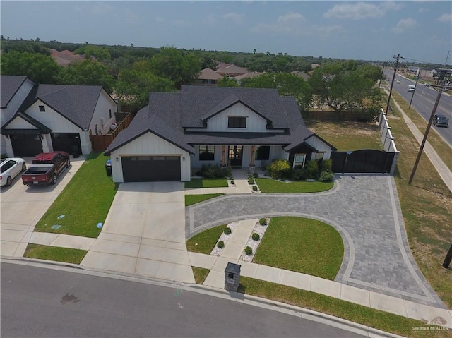 7313 N 25th Ln, Mcallen, TX 78504 - view of front of house with curved driveway, a garage, fence, and a front yard