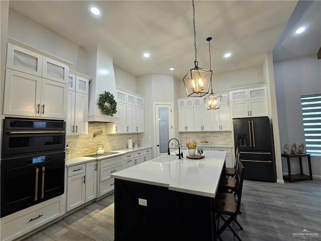 7313 N 25th Ln, Mcallen, TX 78504 - kitchen featuring backsplash, a sink, black appliances, and light countertops