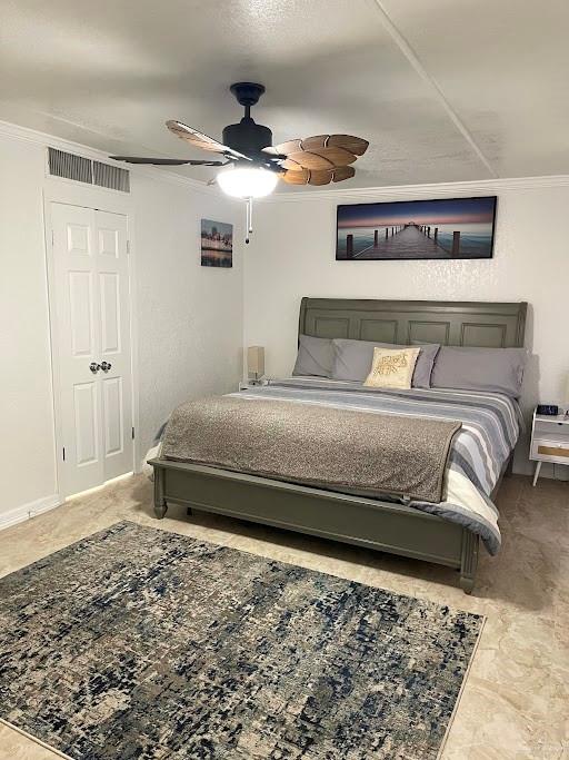 bedroom featuring ceiling fan and crown molding