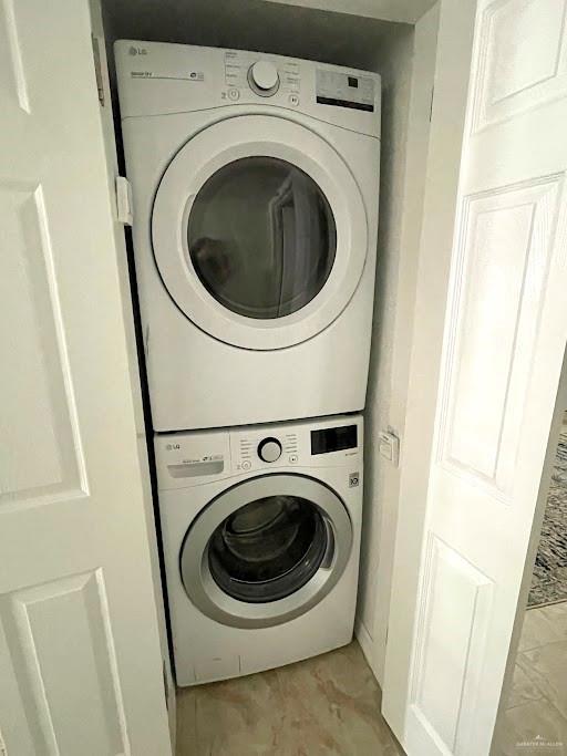 washroom with stacked washer / dryer