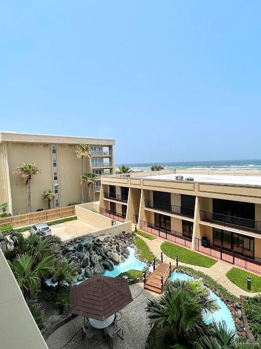 exterior space featuring a water view and a view of the beach