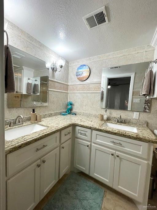 bathroom with vanity and a textured ceiling