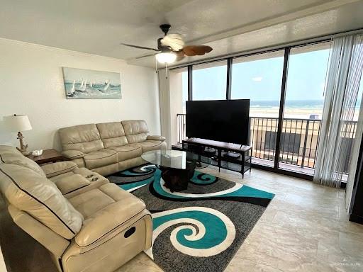 living room with ceiling fan and expansive windows