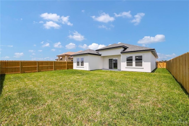 2117 Zinnia St, Weslaco, TX 78596 - back of house featuring stucco siding, a fenced backyard, and roof with shingles