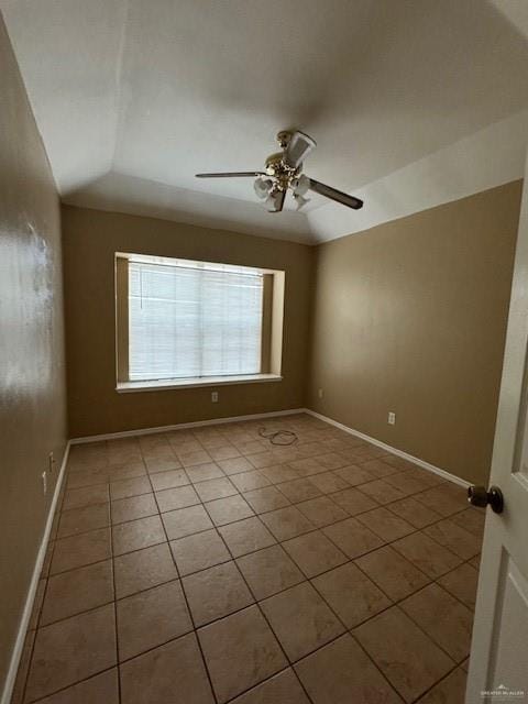 tiled empty room featuring ceiling fan and lofted ceiling