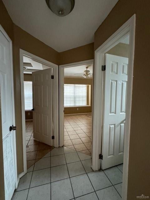 hall featuring light tile patterned floors