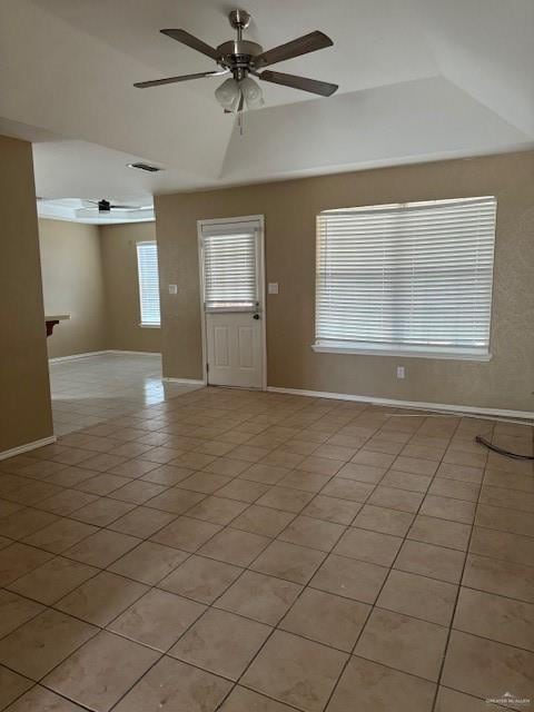 tiled spare room with ceiling fan