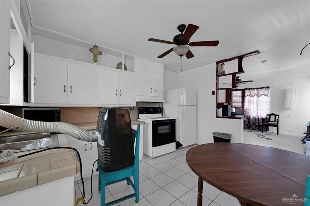 421 W Champion St, Edinburg, TX 78539 - kitchen with electric stove, ceiling fan, freestanding refrigerator, under cabinet range hood, and white cabinets