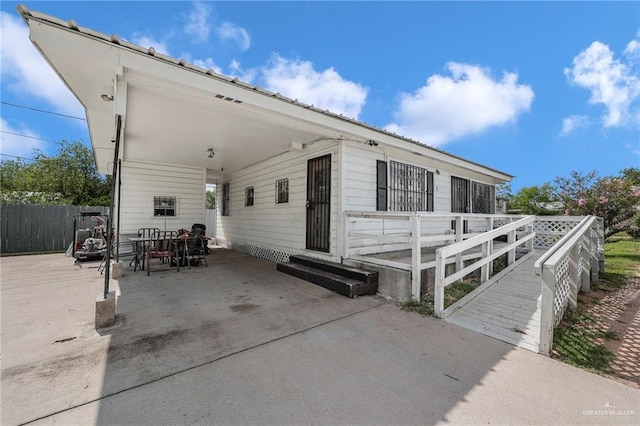 421 W Champion St, Edinburg, TX 78539 - view of patio / terrace with an attached carport, entry steps, and outdoor dining space
