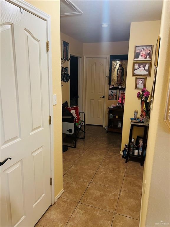 hall featuring light tile patterned floors