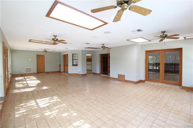 unfurnished living room featuring ceiling fan and light tile patterned flooring