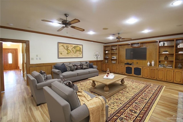 living room with ceiling fan, light hardwood / wood-style floors, and ornamental molding