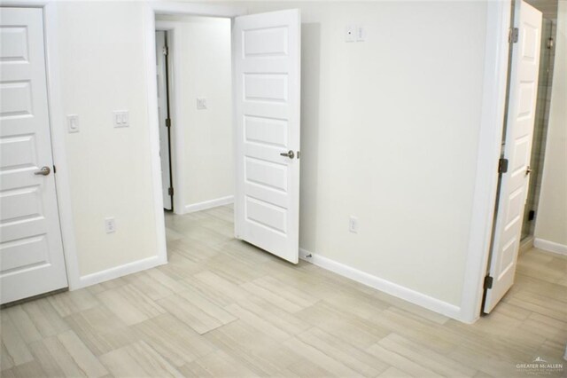 2904 E Israel Ave, Alton, TX 78573 - unfurnished bedroom with baseboards and light wood-type flooring