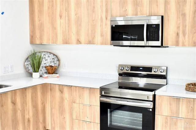 2904 E Israel Ave, Alton, TX 78573 - kitchen featuring stainless steel appliances, modern cabinets, light countertops, and light brown cabinets