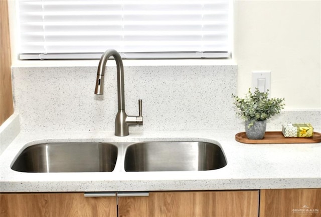 2904 E Israel Ave, Alton, TX 78573 - kitchen view of a sink, brown cabinets, and light stone countertops