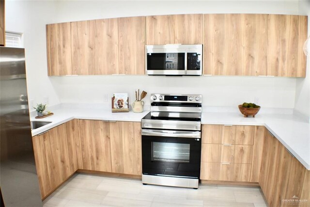 2904 E Israel Ave, Alton, TX 78573 - kitchen featuring appliances with stainless steel finishes, modern cabinets, light countertops, and light brown cabinetry