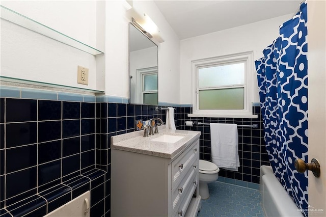1821 Palm Blvd, Brownsville, TX 78520 - full bathroom with tile walls, vanity, tile patterned flooring, toilet, and a wainscoted wall