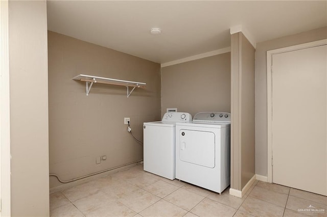 1821 Palm Blvd, Brownsville, TX 78520 - laundry area with washer and clothes dryer and light tile patterned floors