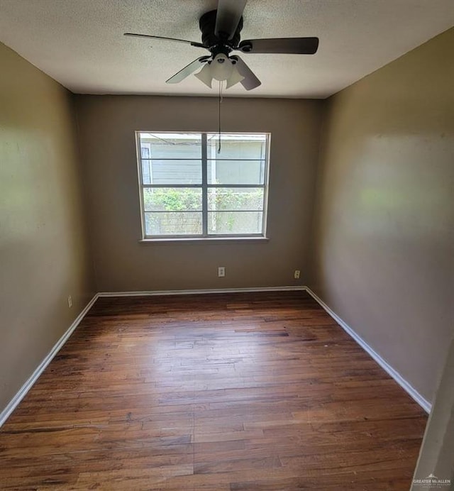3135 Southmost Rd, Brownsville, TX 78521 - unfurnished room with a textured ceiling, a ceiling fan, dark wood-style floors, and baseboards
