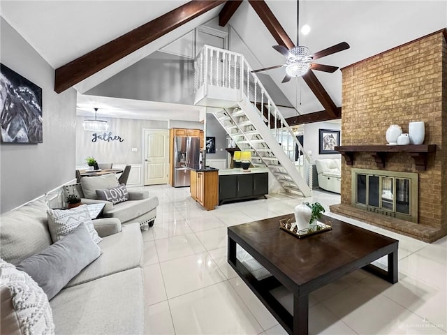 living room with ceiling fan, light tile patterned floors, beam ceiling, high vaulted ceiling, and a fireplace