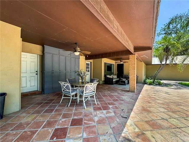 view of patio / terrace with ceiling fan and an outdoor living space