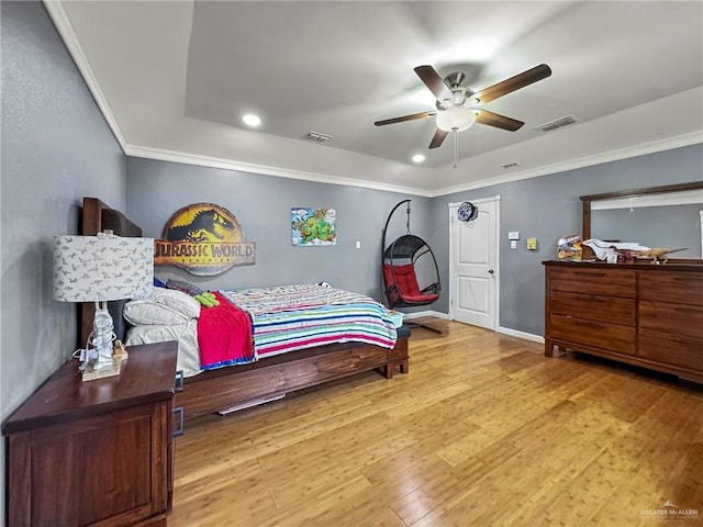 bedroom with ceiling fan, light wood-type flooring, and crown molding