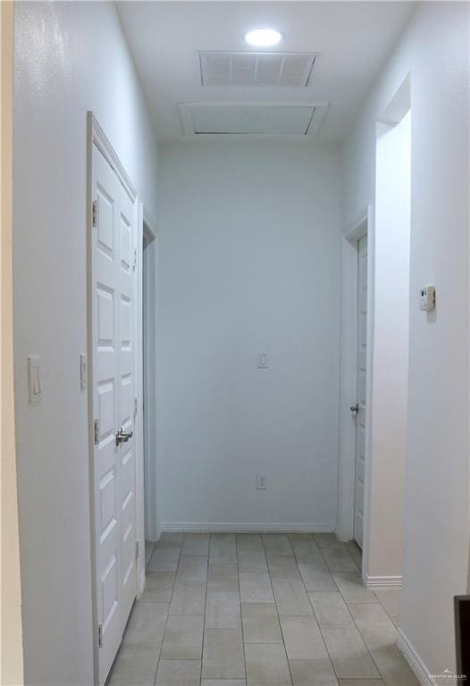 corridor with light tile patterned floors