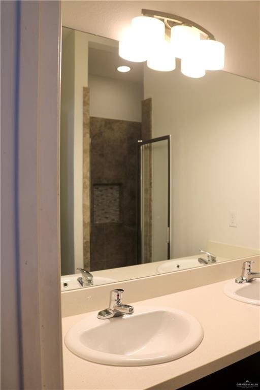 bathroom with vanity and a tile shower