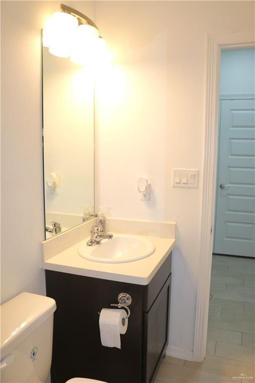 bathroom with vanity and toilet