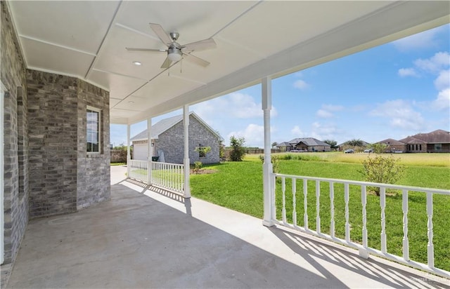 view of patio / terrace with ceiling fan and a garage