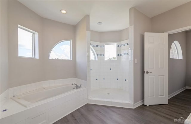 27406 S Kelly Ct, La Feria, TX 78559 - bathroom featuring a bath, wood finished floors, and tiled shower